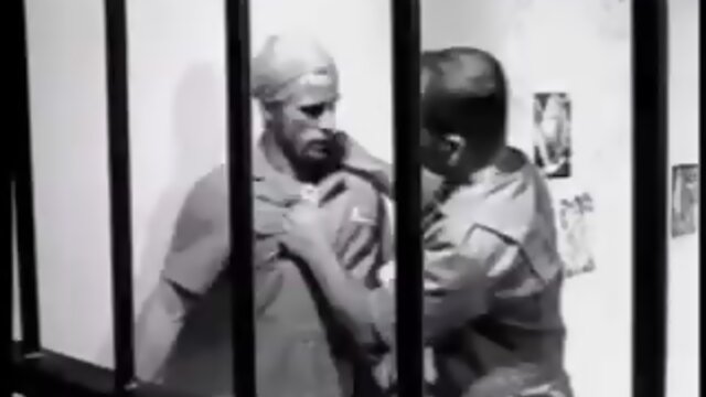 Guy with long blond hair in prison