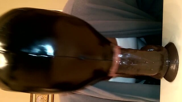 Practicing deepthroat with dildo.