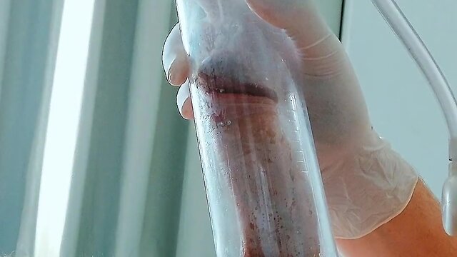 Putting on latex medical gloves while pumping a penis